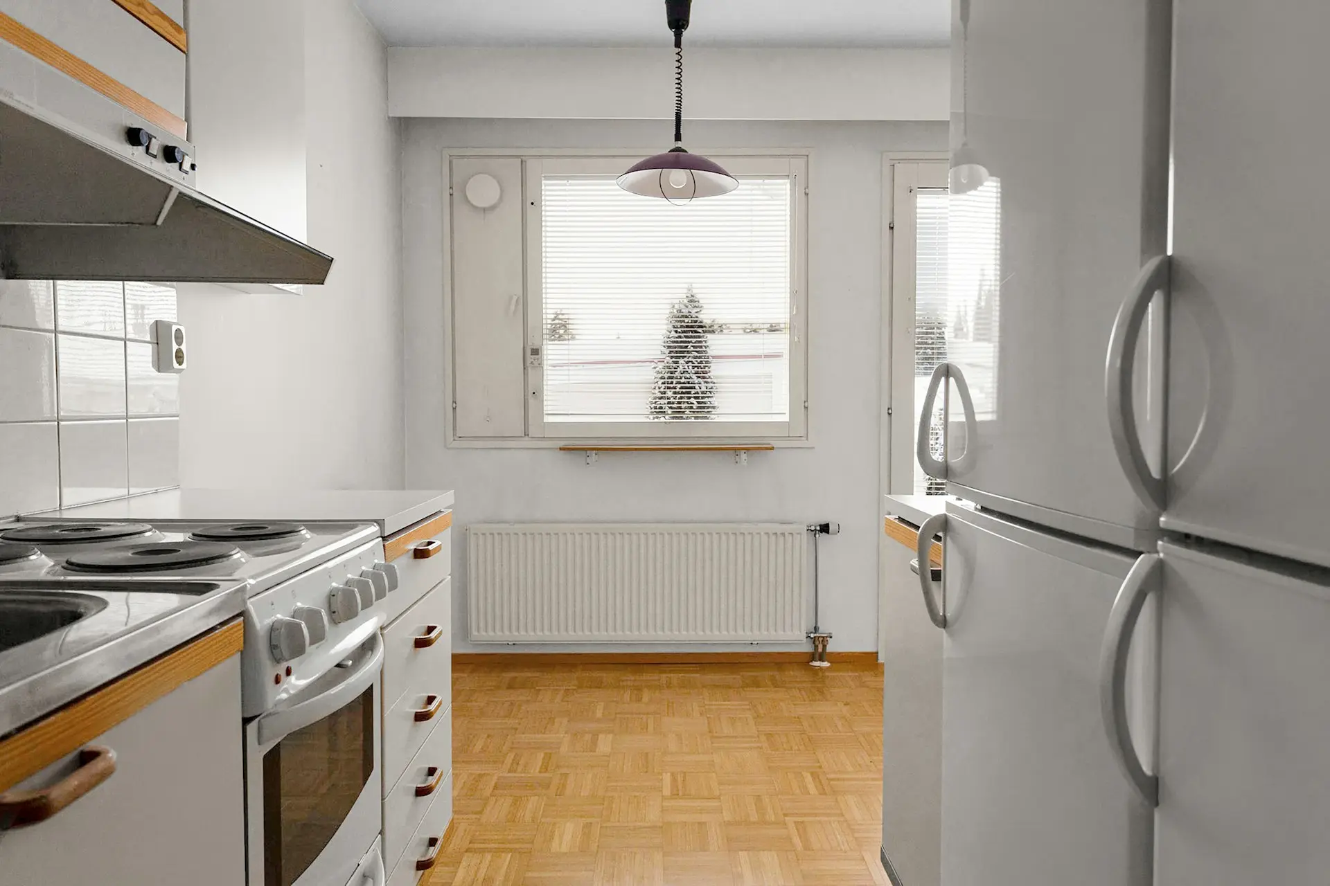 A white refrigerator freezer sitting inside of a kitchen